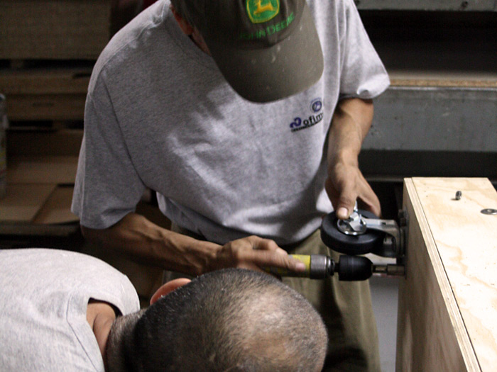 Assembling the wheels with an awesome air-powered driller!