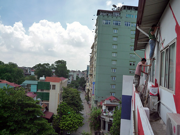 Duy and Thăng painting the fifth floor Duy and Thăng painting the fifth floor